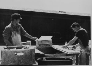 Men filleting fish on the quayside