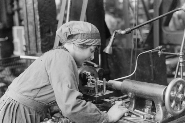 Operating a Lathe Photo of woman worker operating a lathe