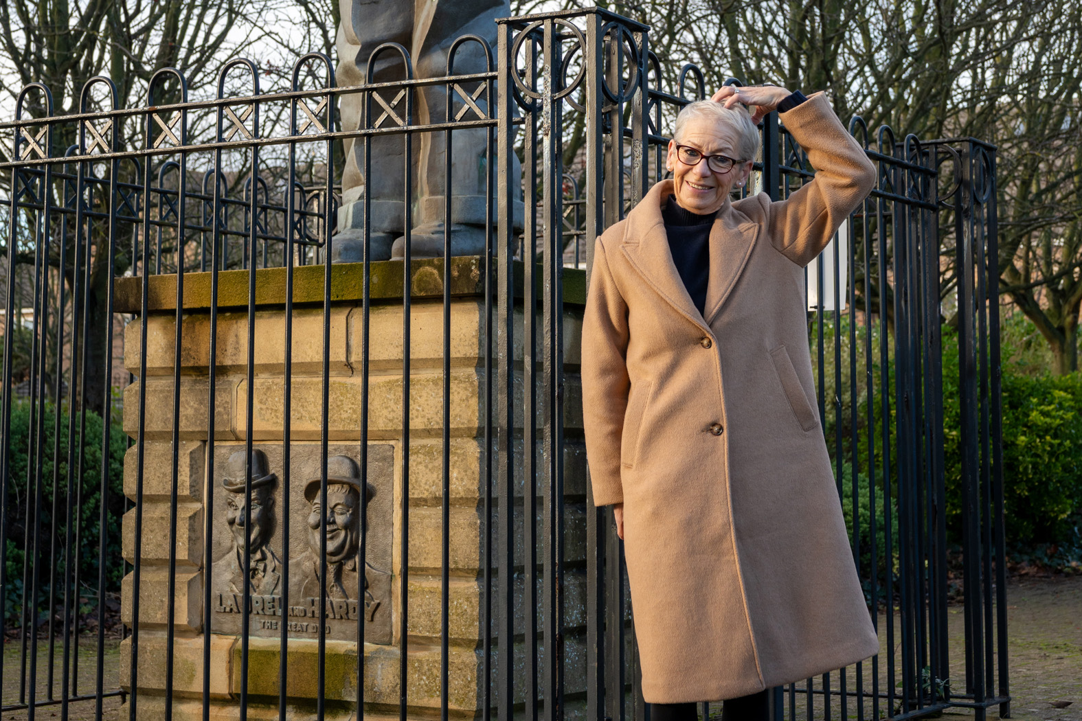 Linda McLeod beside Stan Laurel statue in Laurel Park