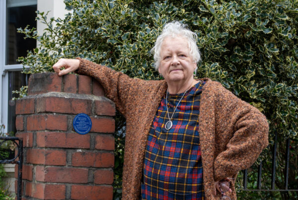 Caroline Kemp beside blue plaque