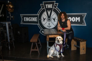 Photo of John Hill in the Engine Room with his dog