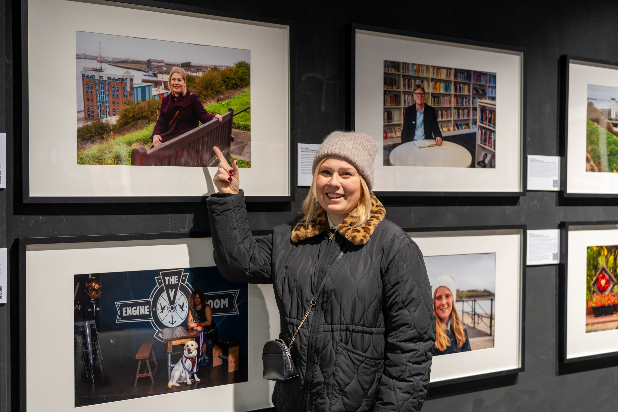 A contributor next to their photo at our North Shields Voices exhibition at the Beacon Centre